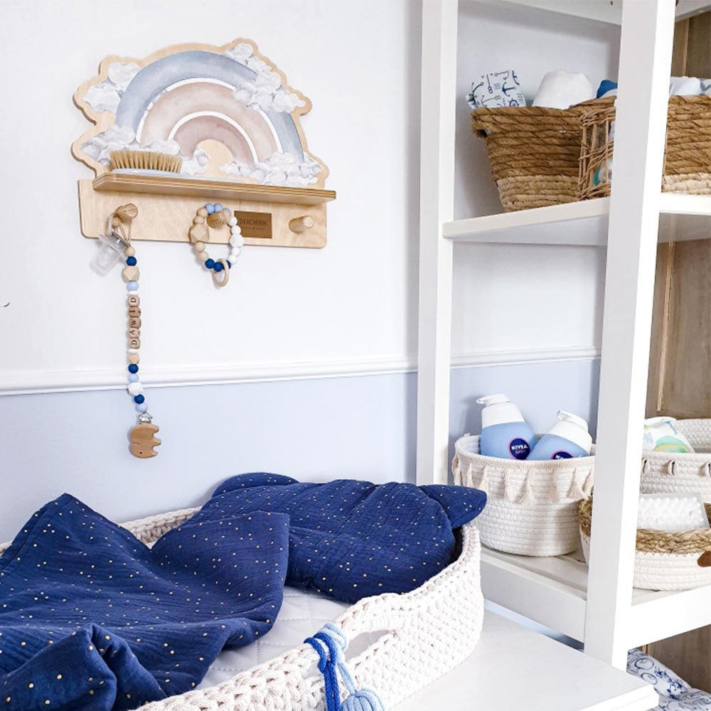 bold blue rainbow wall shelf with a playful dinosaur sticker, mounted on a bright wall