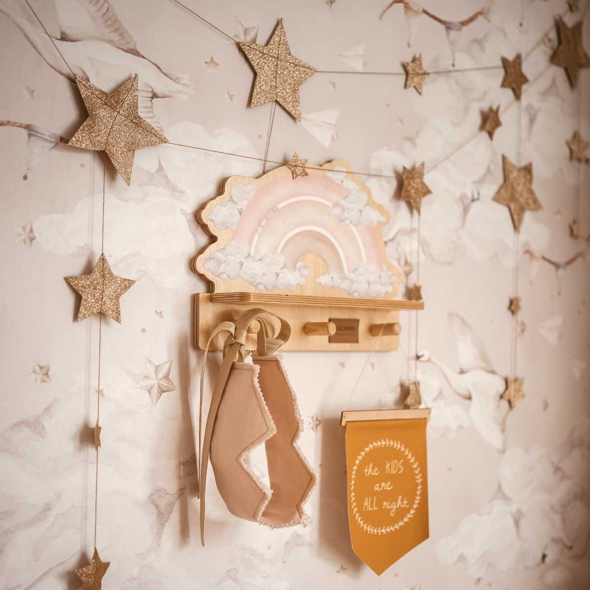 bold pink rainbow shelf with a playful dinosaur graphic in bright morning light