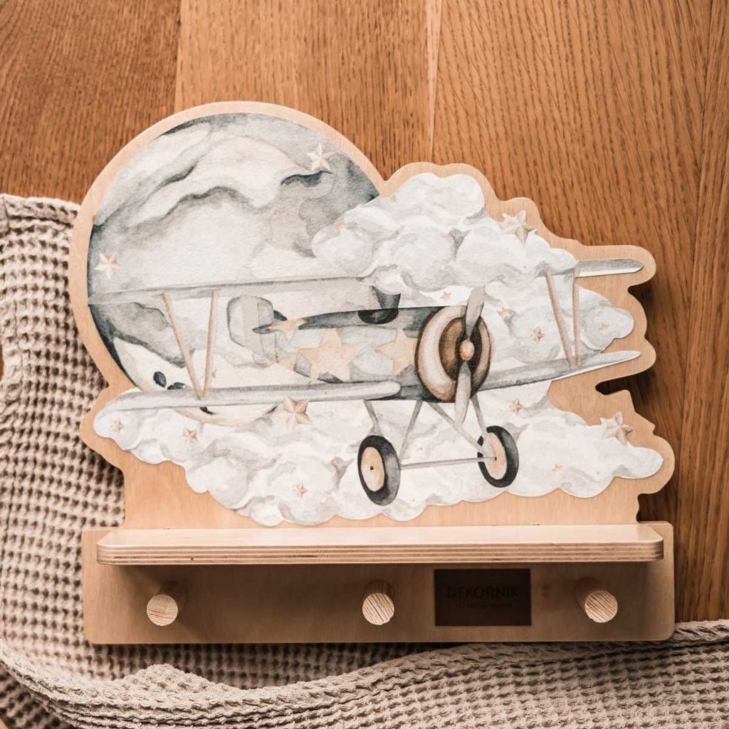 softly lit mini dinosaur wall shelf in a cozy nursery with a plush toy nearby