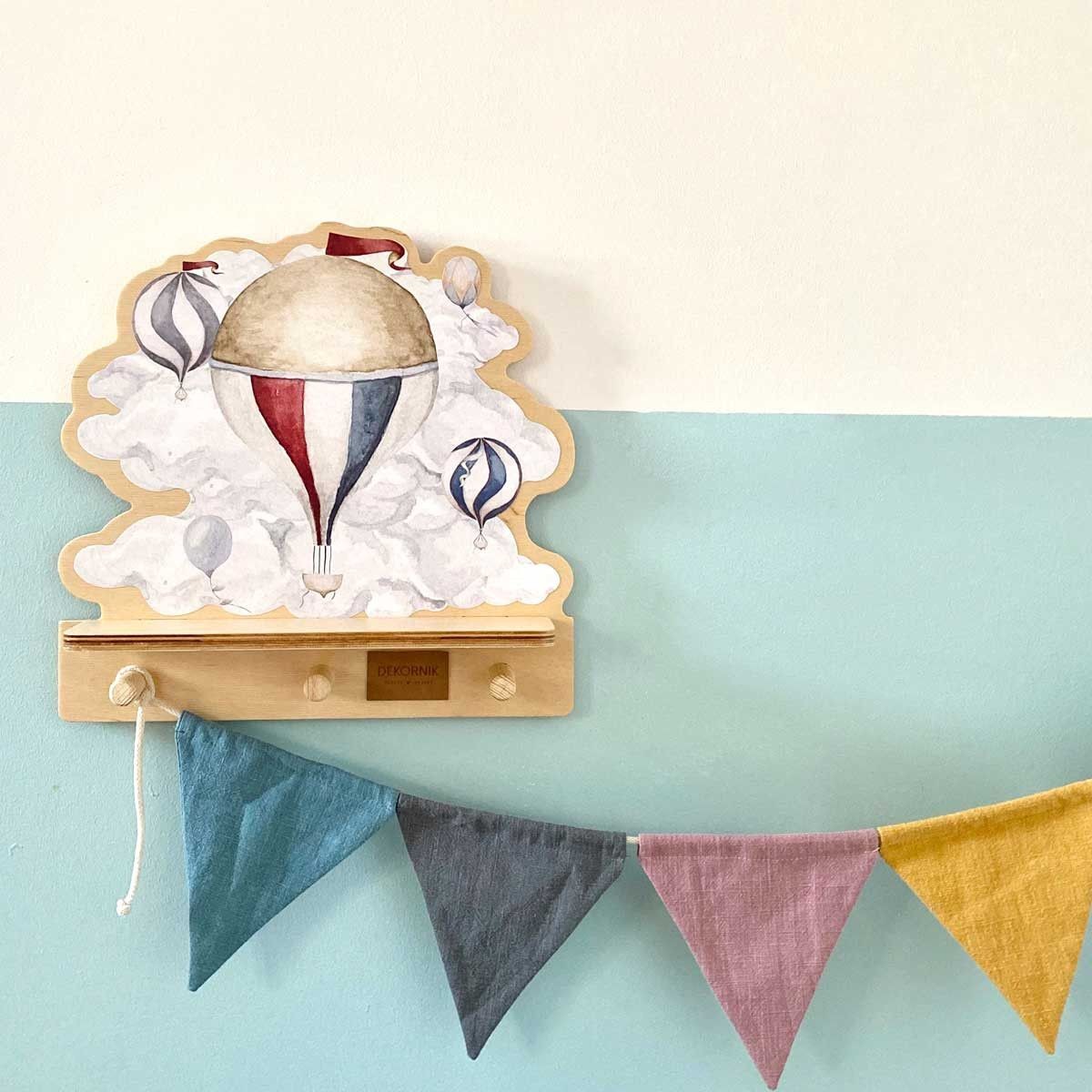 a bold close-up of the vibrant dinosaur mini wall shelf with its three wooden pegs