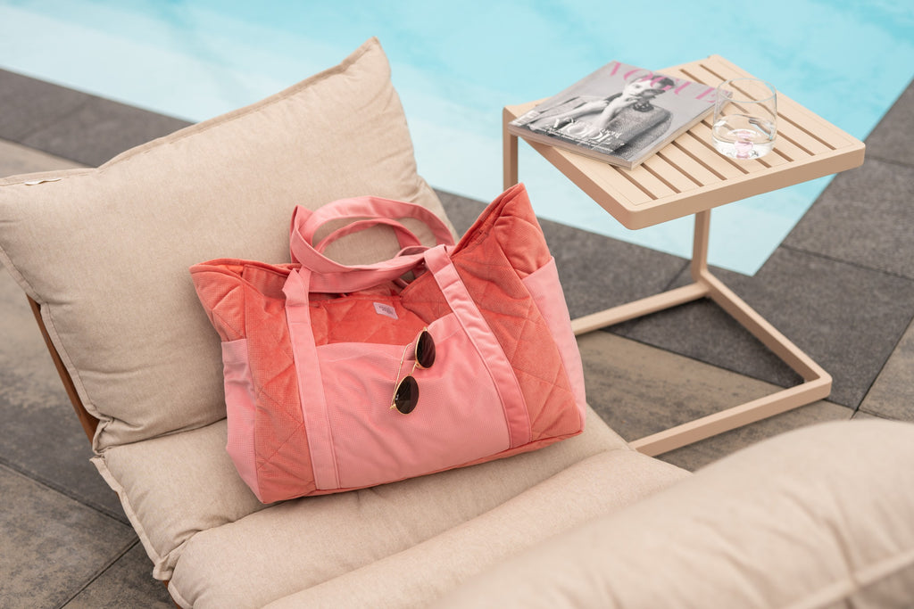 a close-up detail shot of the candy-colored velvet weekender bag's secure zipper and water-resistant lining