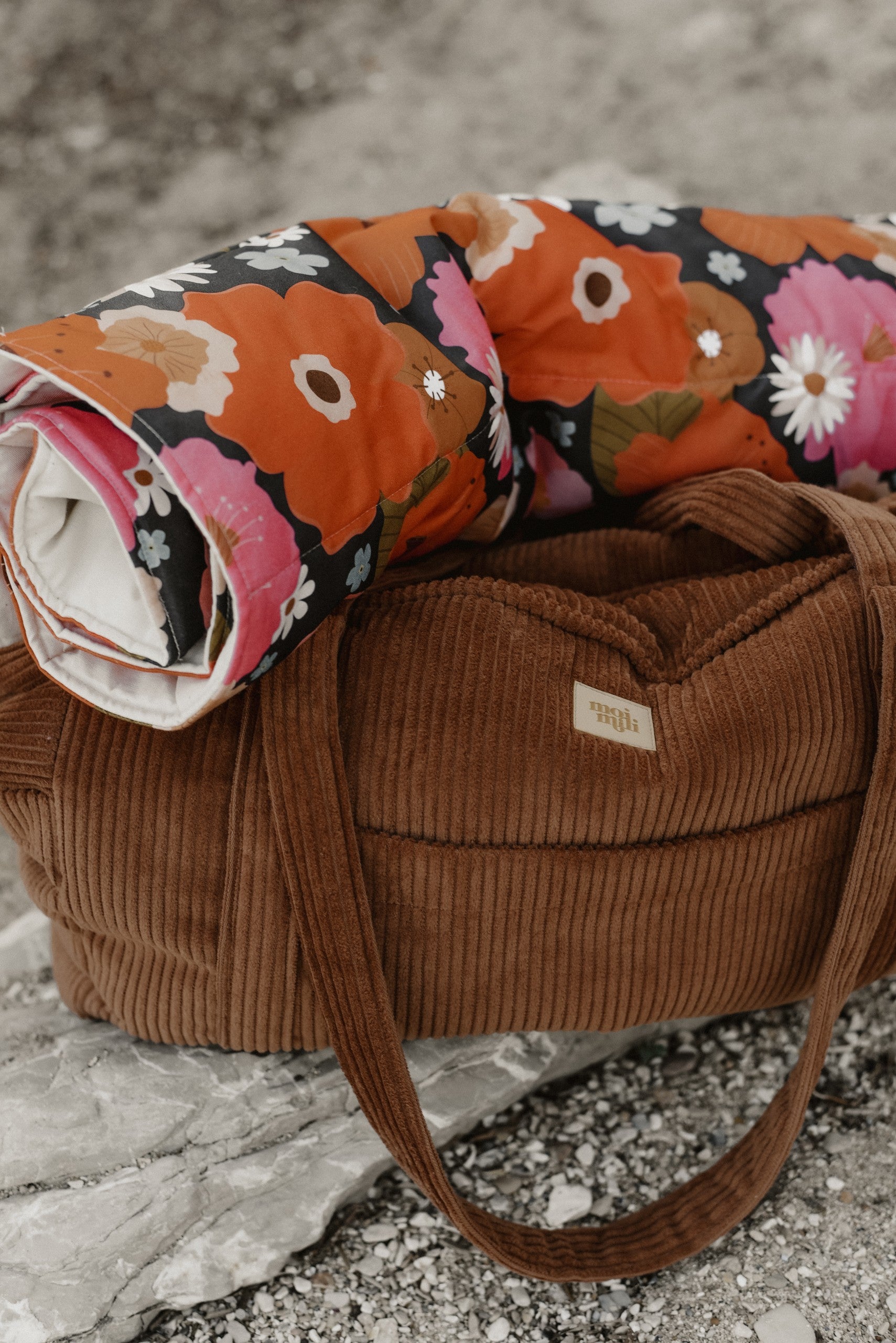 confident woman carrying a stylish handmade caramel weekender bag in golden hour light