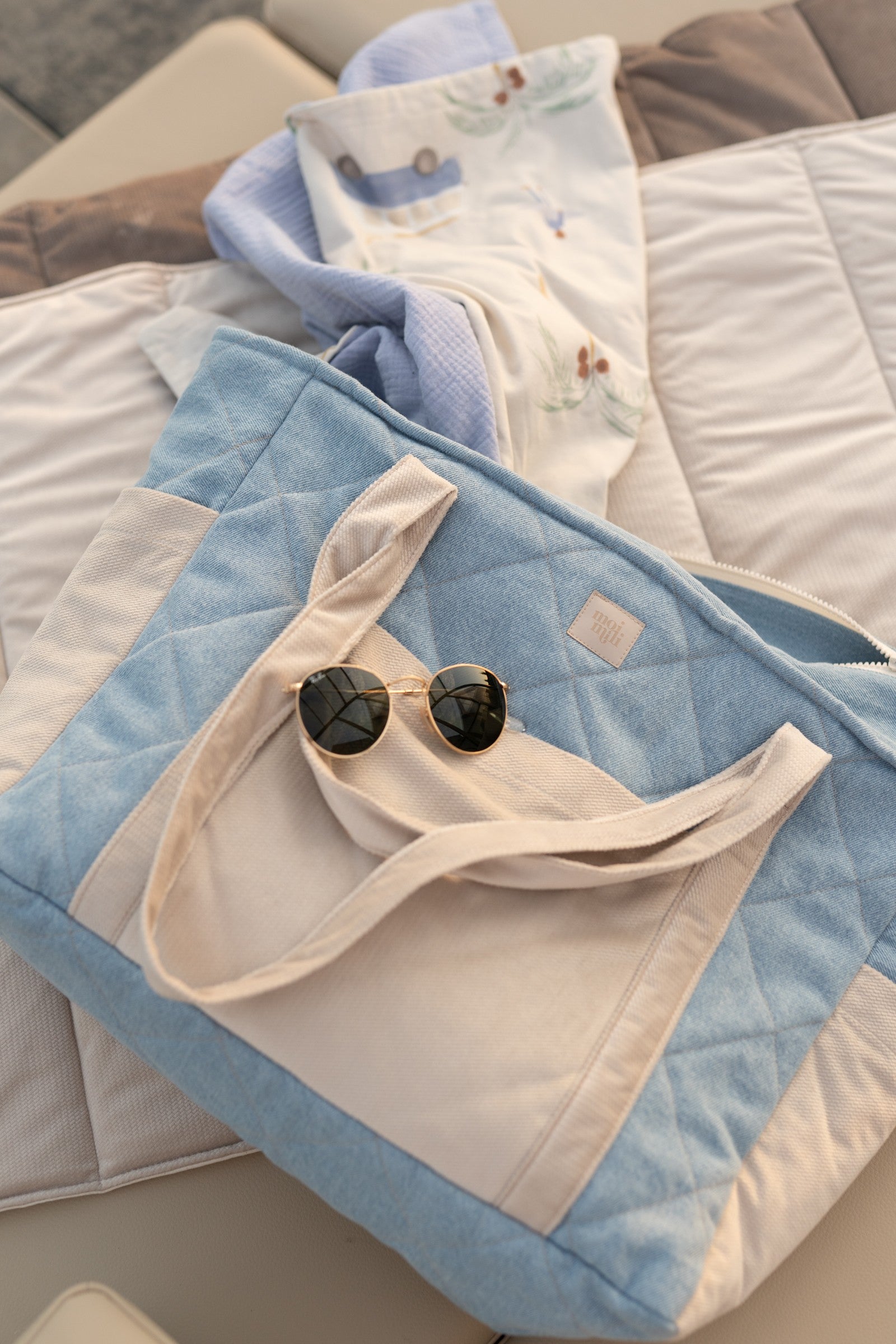 elegant handmade denim weekender bag with dual straps and chic pockets, displayed on a marble surface