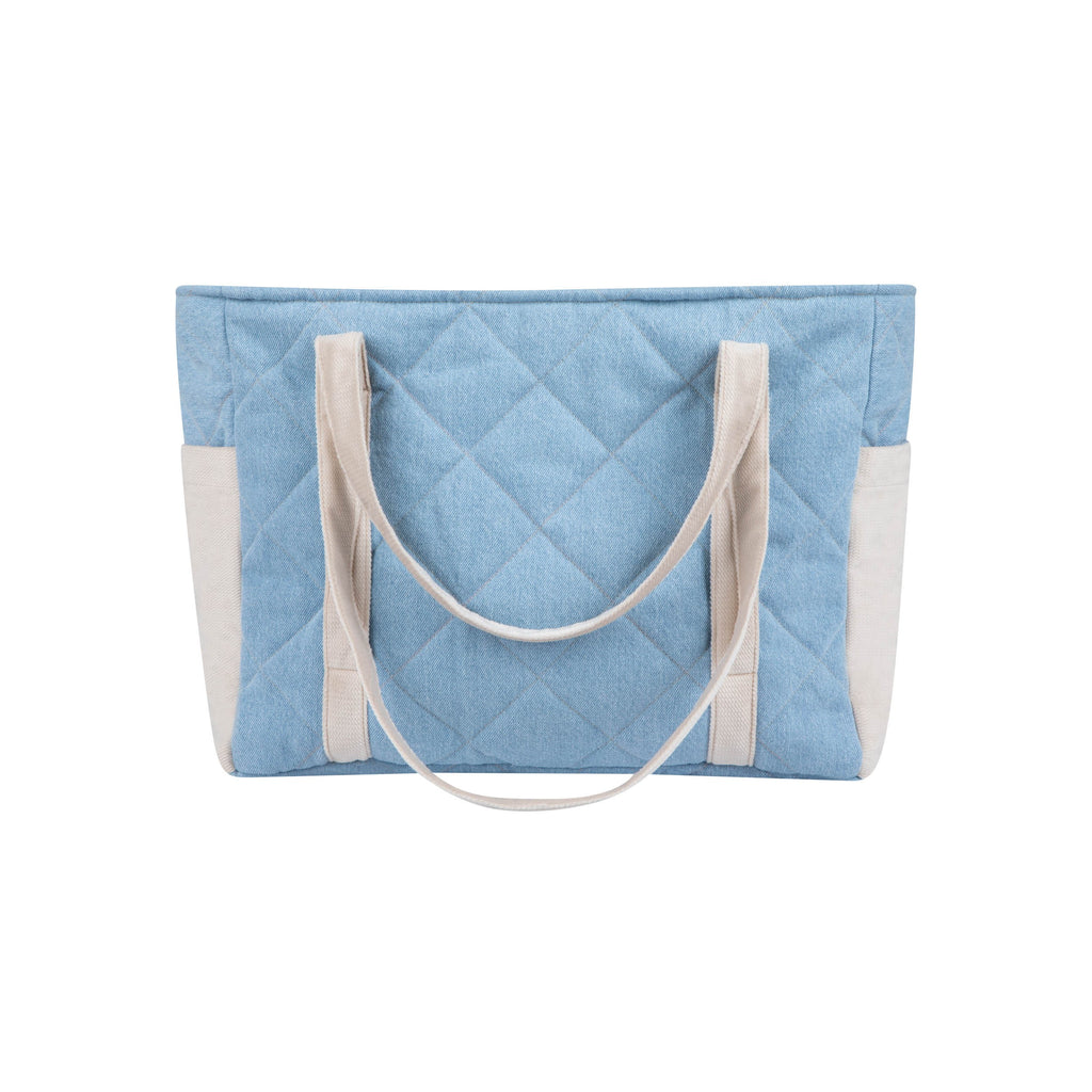 a practical denim weekender bag with multiple pockets open on a park bench