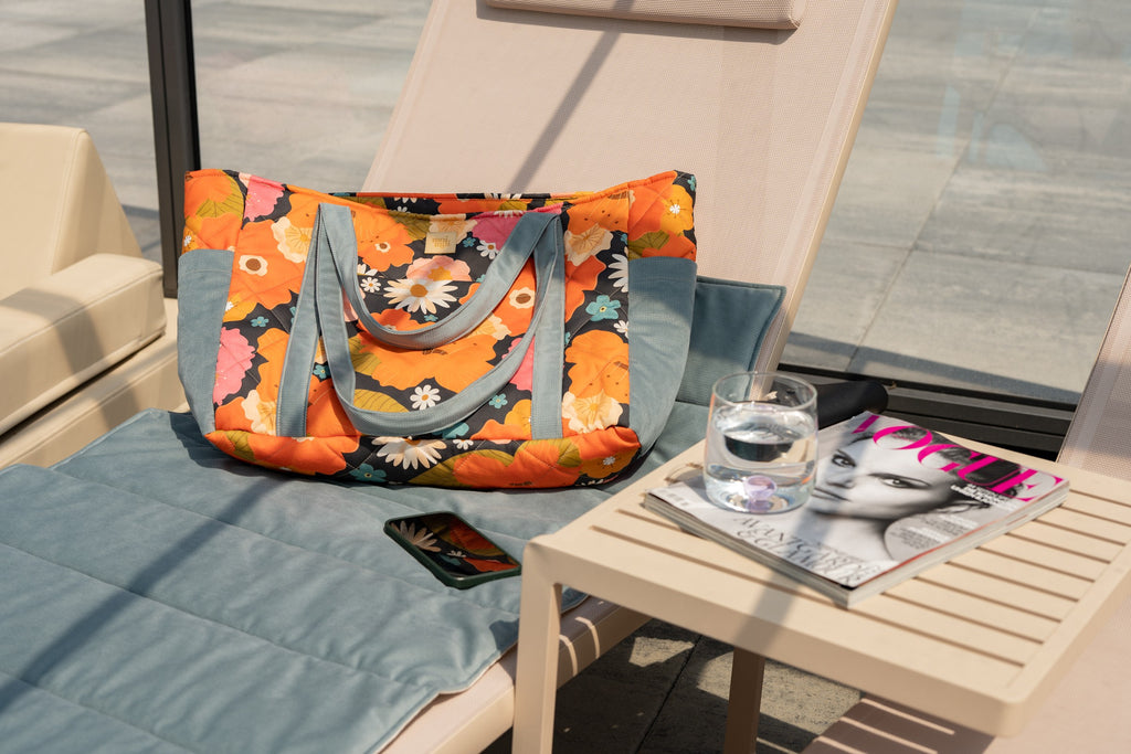 elegant handmade velvet weekender bag with floral picnic print, open to show organized interior pockets