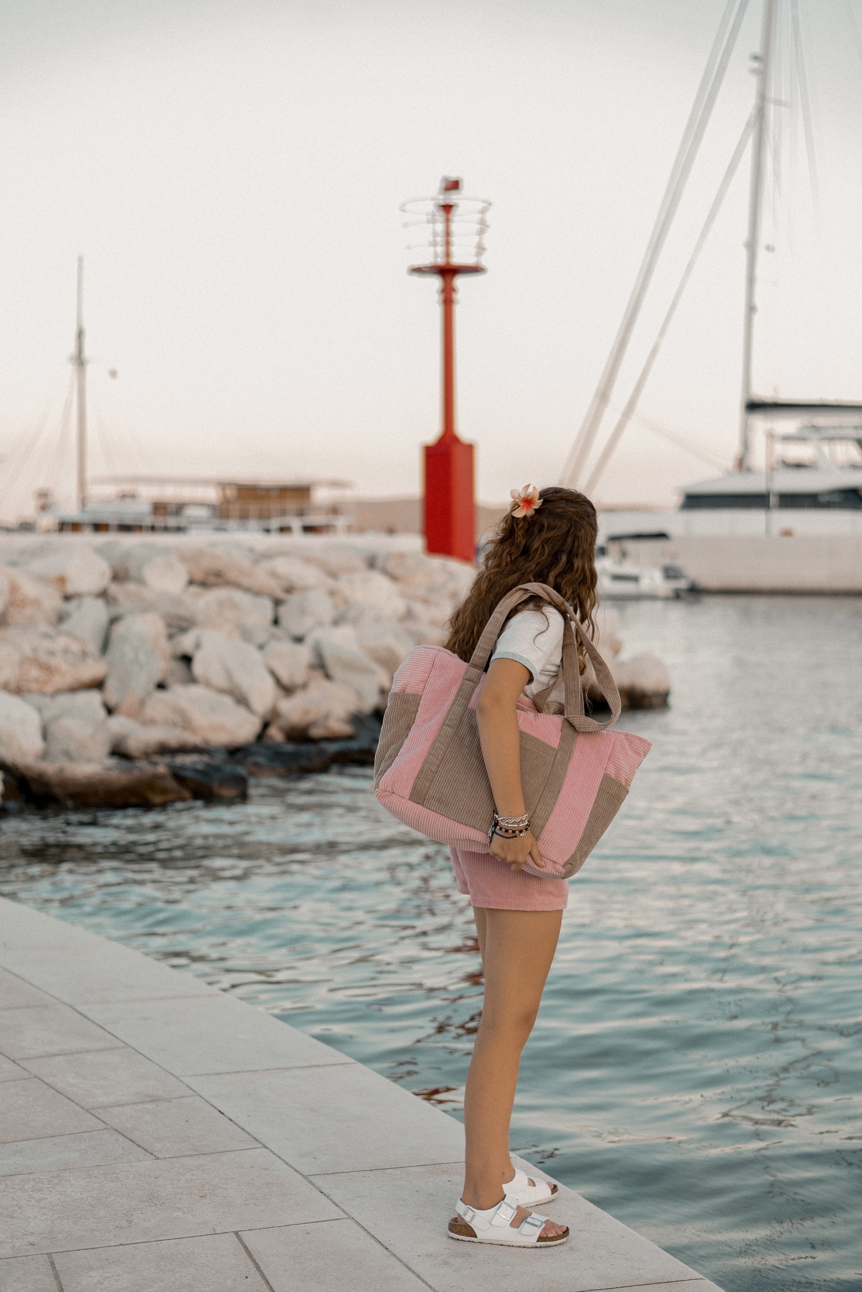 bold pink velvet weekender bag with multiple pockets, shown confidently on a shoulder