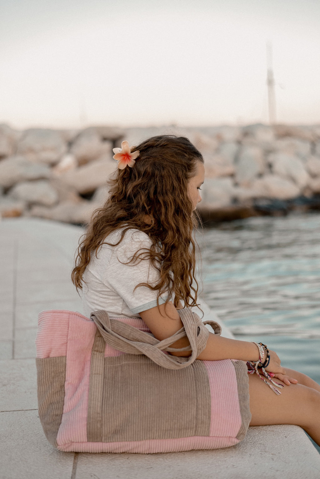 playful pink velvet weekender bag held by a smiling mom, showcasing its lightweight and fun design for adventures