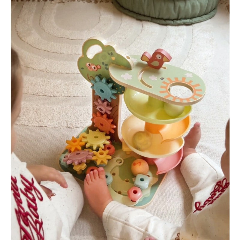 montessori ball track activity tree with spinning gears and bead maze in soft morning light