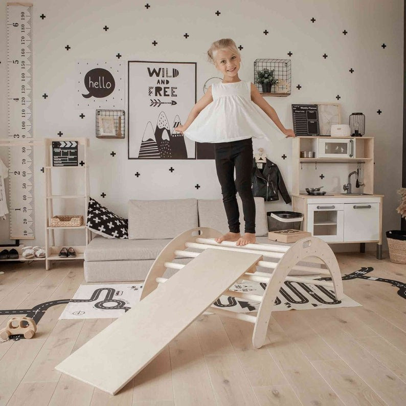 a soft-lit shot of the montessori arch and ramp in a cozy nursery setting