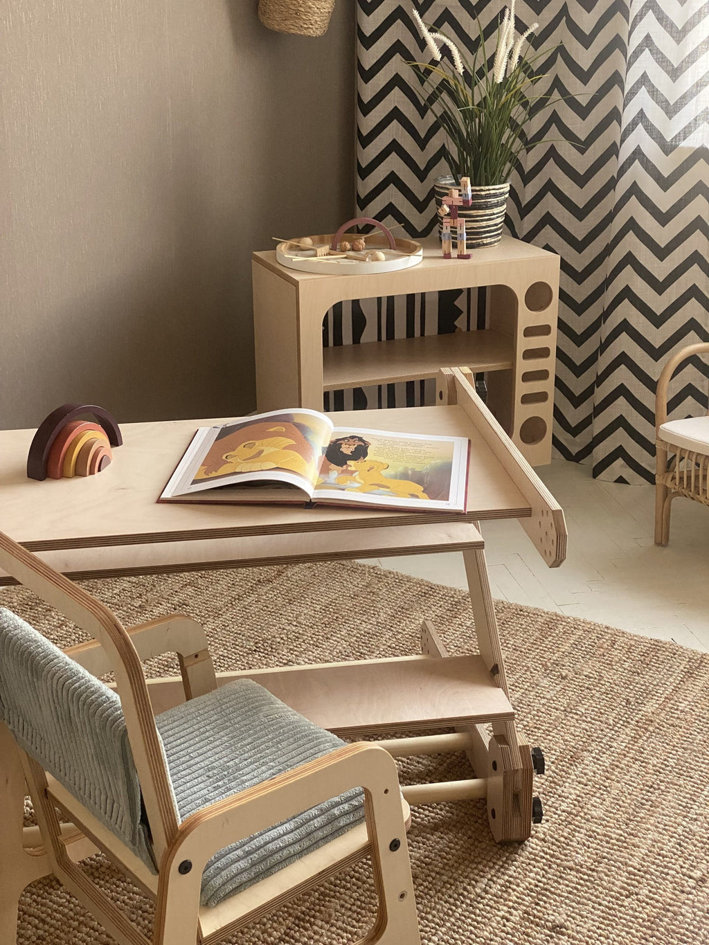 a child drawing on the nabu whiteboard tabletop in a cozy playroom