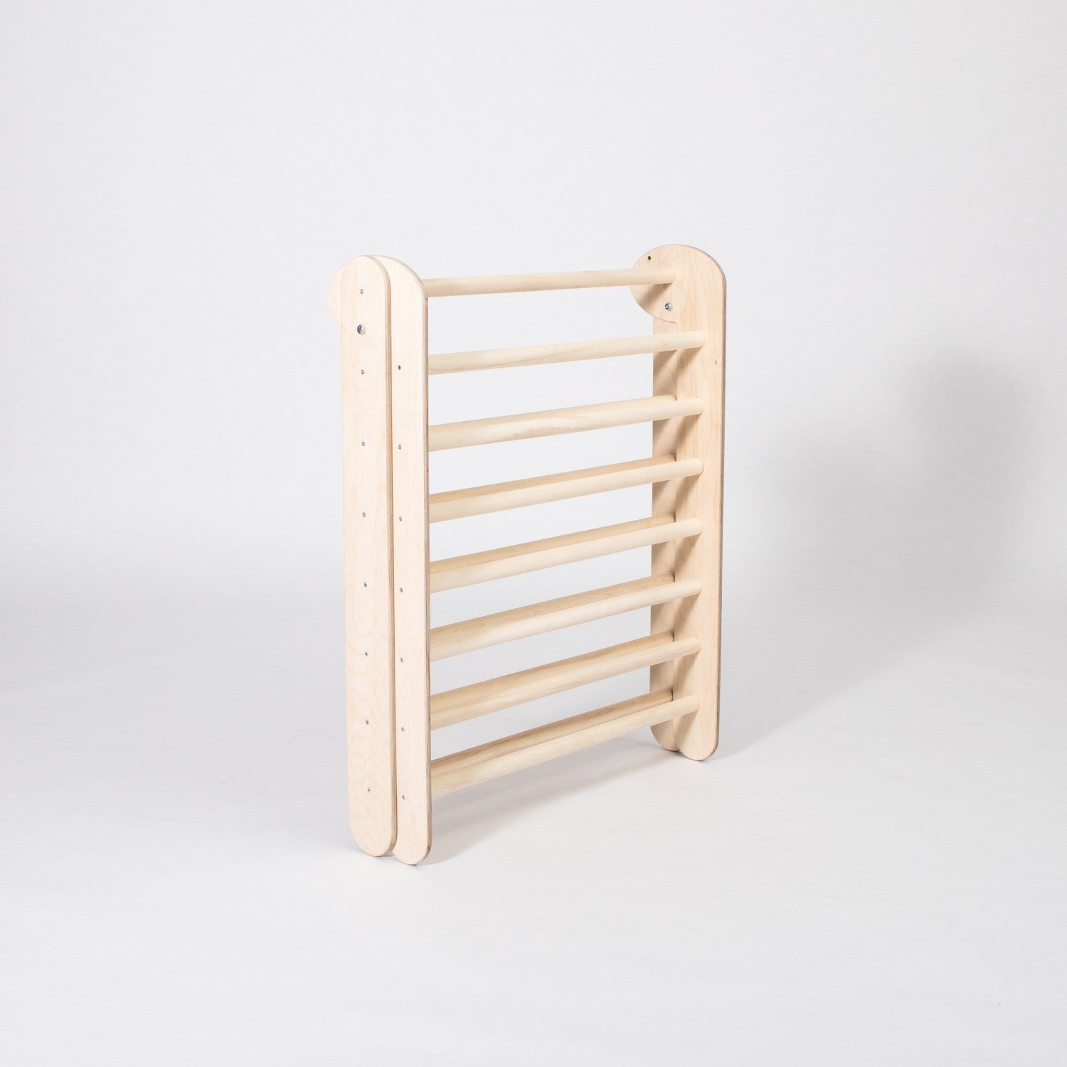 montessori climbing triangle folded for compact storage in a modern nursery