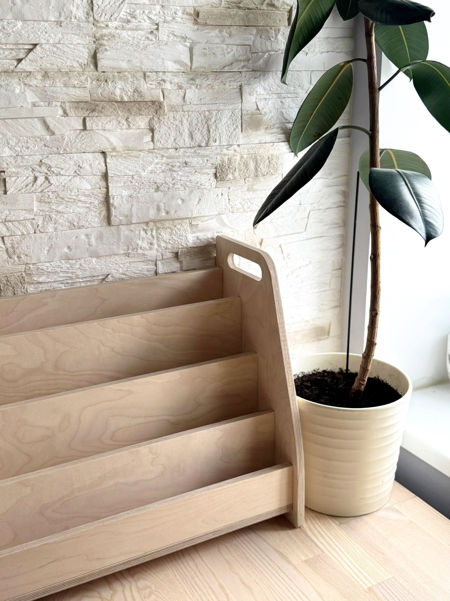 a bold, low-angle shot of the birch plywood book stand, showcasing its sturdy four-tier design