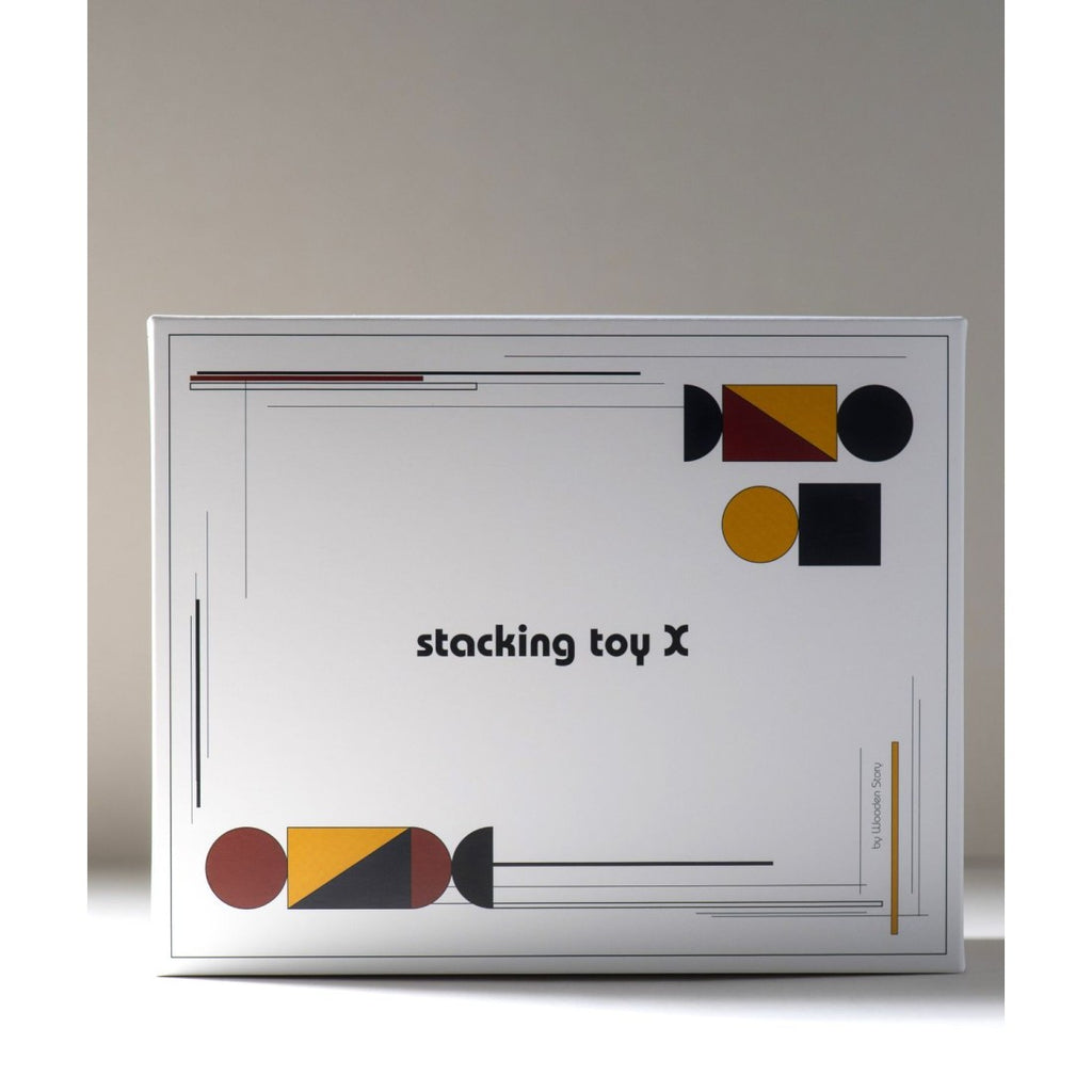 a playful toddler's hand stacking a bauhaus-inspired wooden spaceship