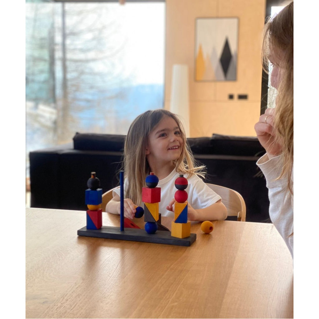 a soft-focus close-up of a wooden stacking toy's smooth, natural grain in gentle morning light
