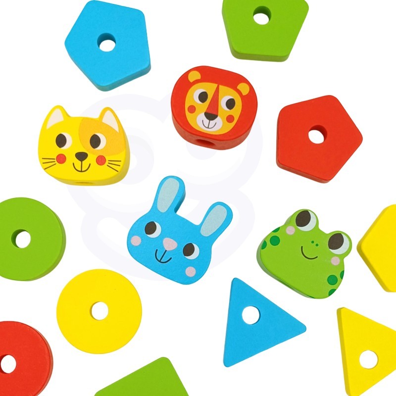 a child's hand placing a colorful wooden giraffe block onto the montessori puzzle pyramid