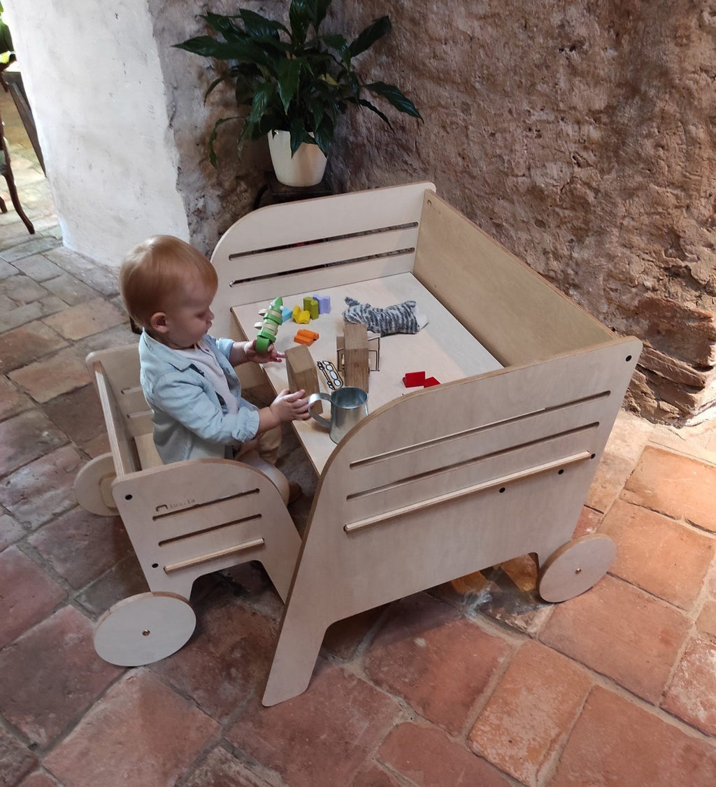 bold front view of the montessori wagon wheel table and chair set in a bright, modern playroom