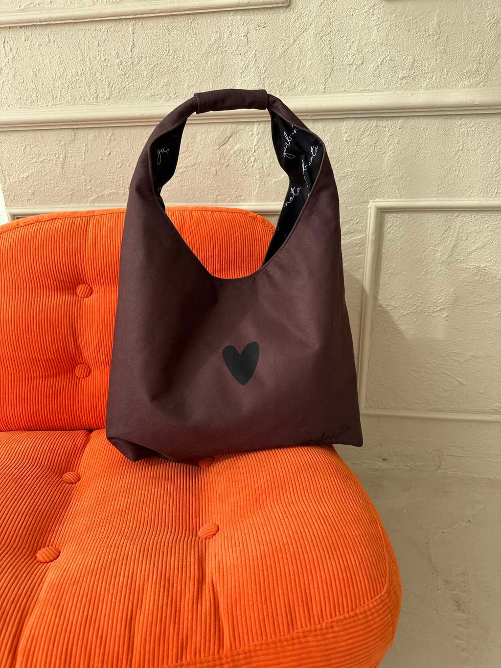 soft brown moon bag heart in comforting morning light, showing its gentle drape and signature garbanota lining