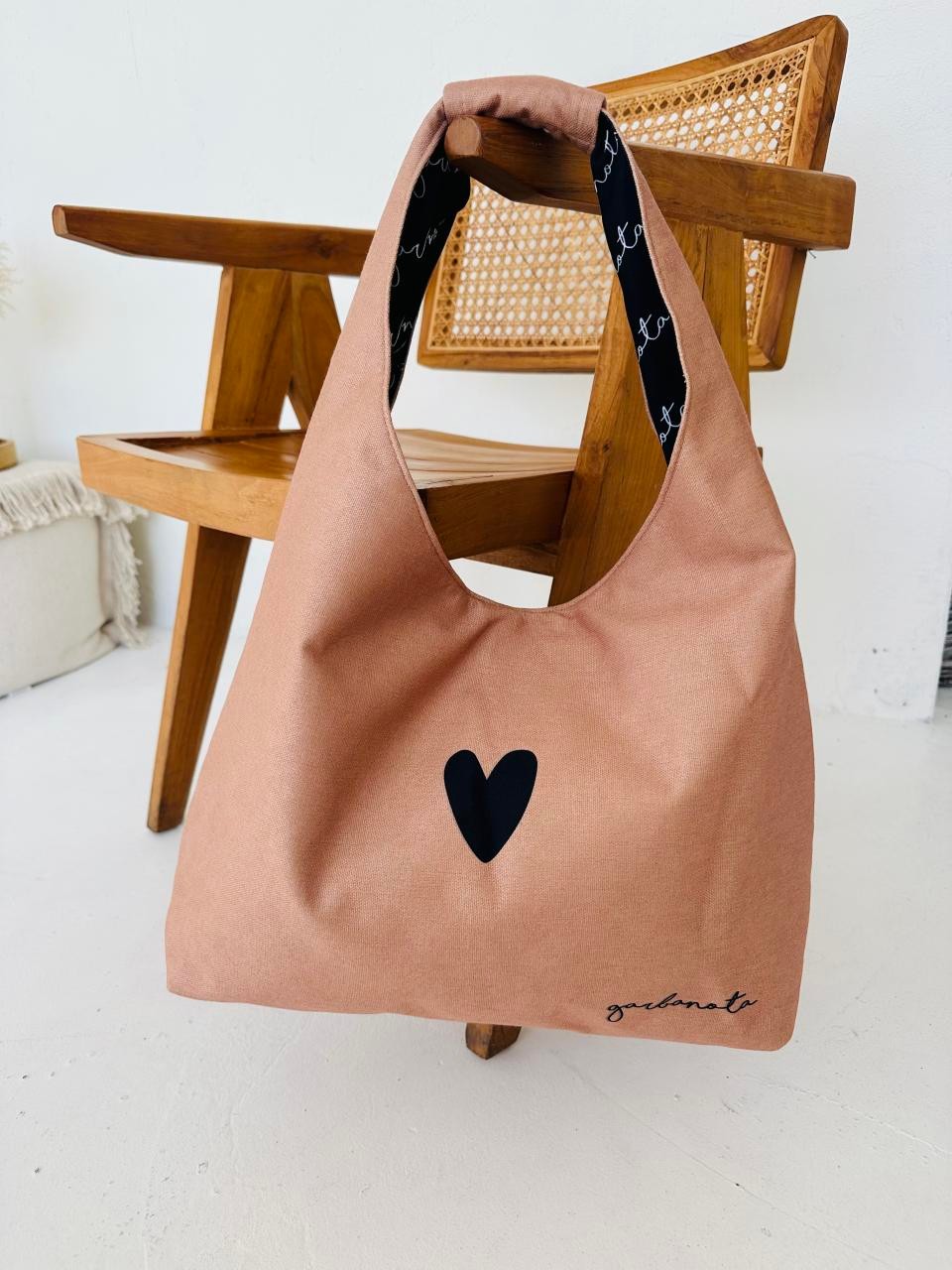 playful cream moon bag heart with its unique garbanota pattern lining on display