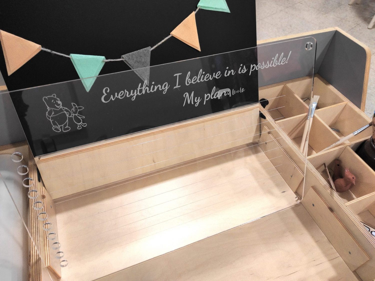 softly lit luula art table with a child's sand drawing in the sensory tray