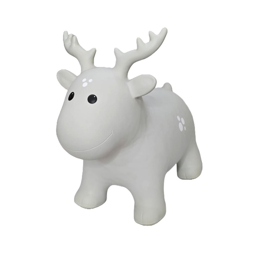 confident toddler bouncing on a grey moose hopper toy indoors