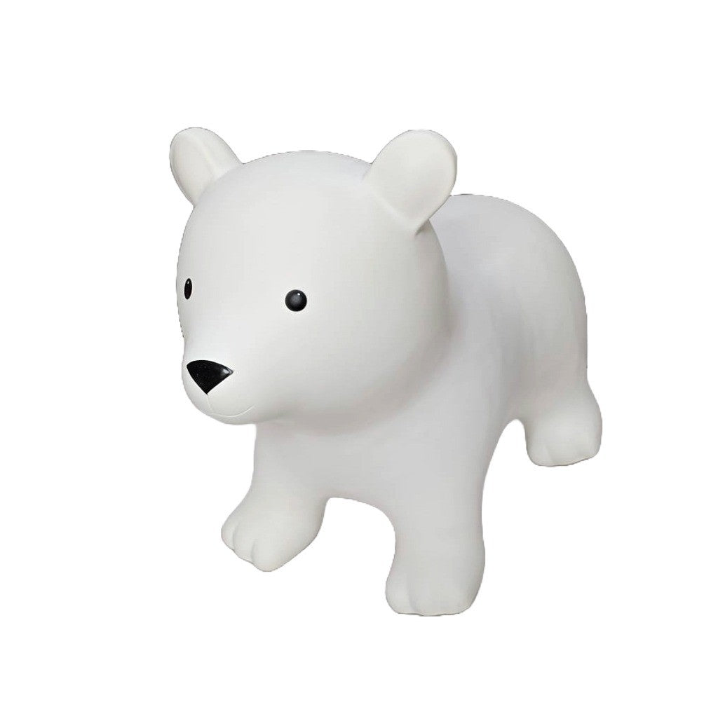 confident toddler bouncing high on a white bear jumpy toy indoors