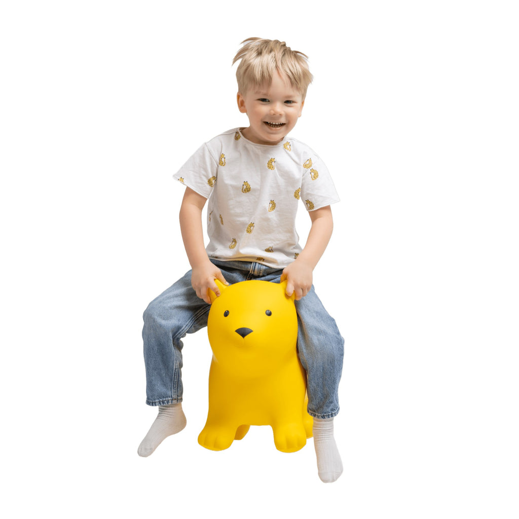 a bold close-up of the yellow bear jumpy toy on a vibrant play mat, showcasing its durable non-slip texture