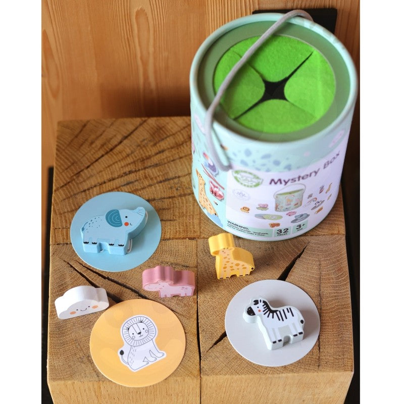 child's hand reaching into the eco-friendly wooden mystery box to find a shape