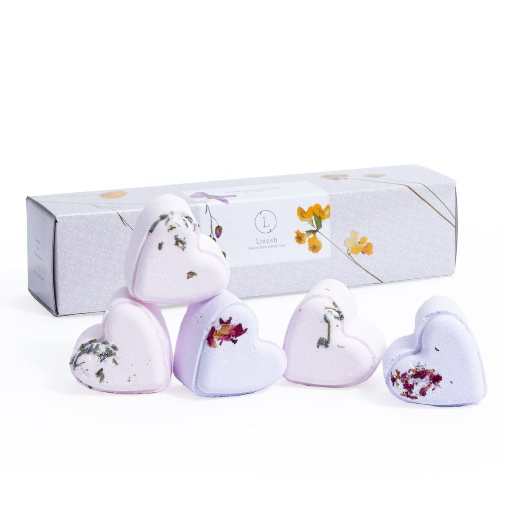 bold close-up of handmade lavender heart shower steamers on dark slate