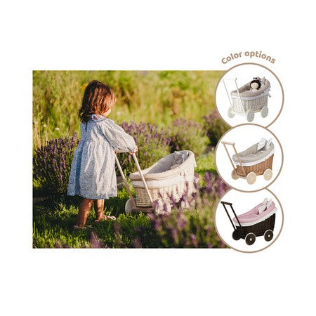 a close-up detail of the natural wicker weave and soft beige bedding in the charming luna doll pram