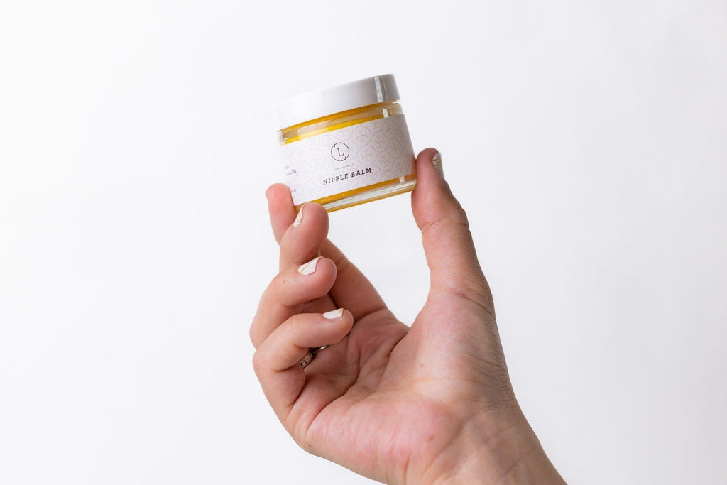 softly lit natural nipple balm in a cotton bag, a comforting and sustainable gift for new mothers