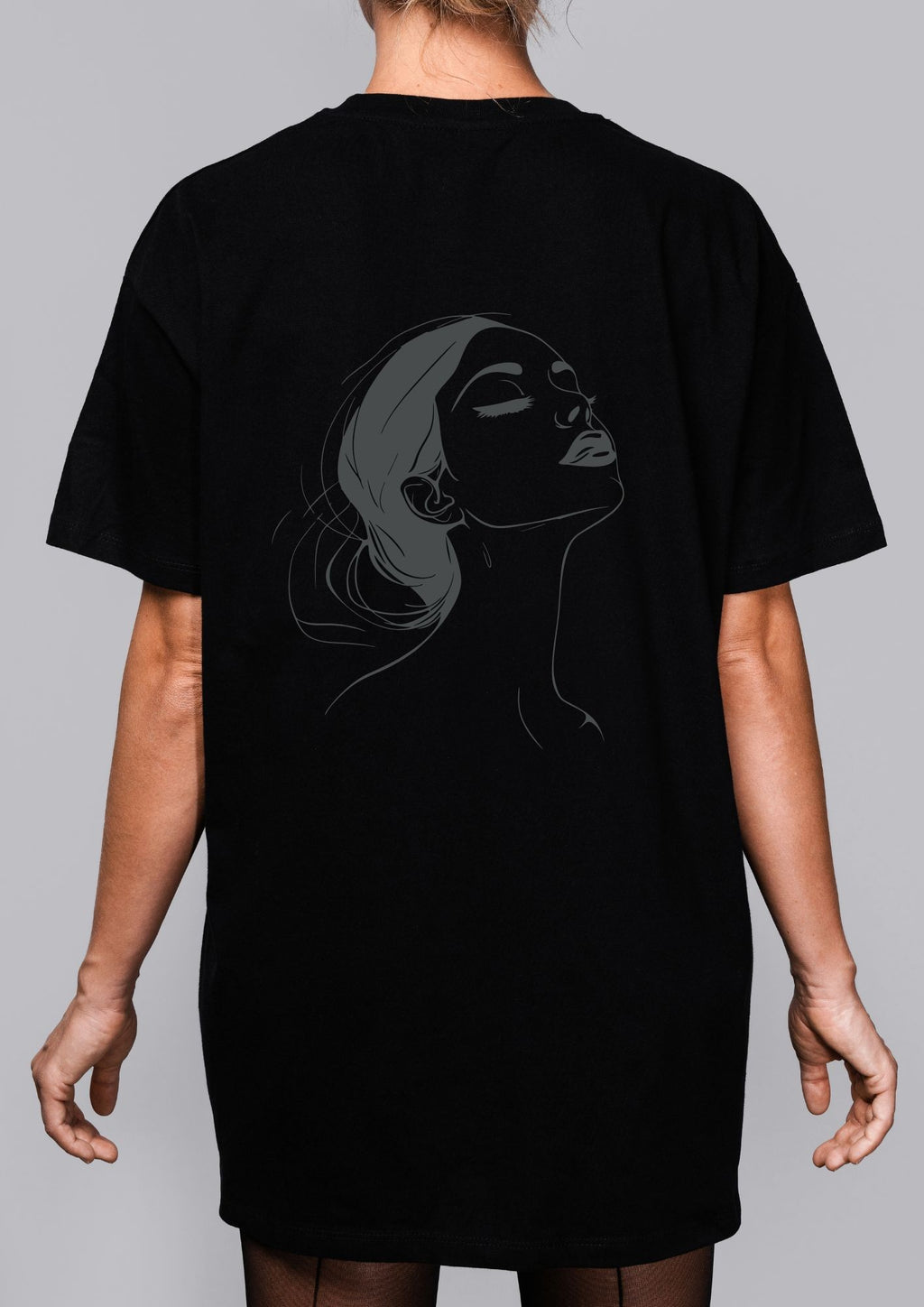 a playful close-up of the no drama please tee, showing the witty back illustration in warm, inviting light