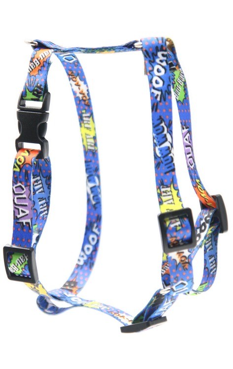 a soft blue graffiti dog harness with gentle lighting on a cozy bed