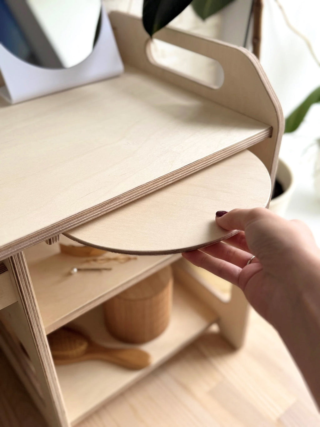 elegant wooden toddler washbasin with enamel bowl in a refined, natural light setting