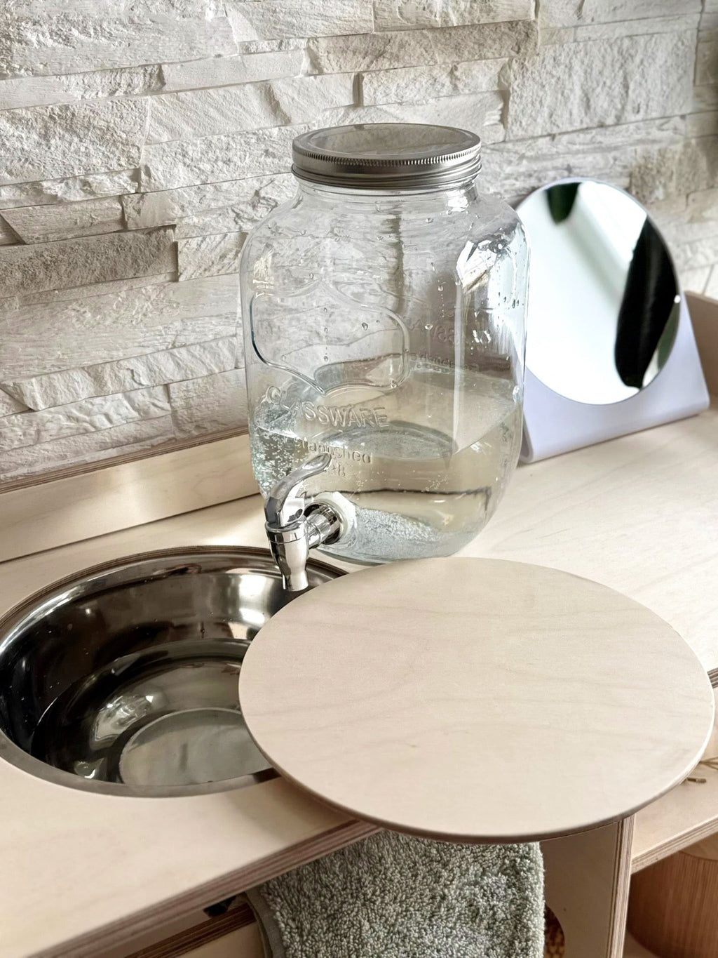 montessori wooden washbasin for toddlers in a bright, minimalist room with morning light