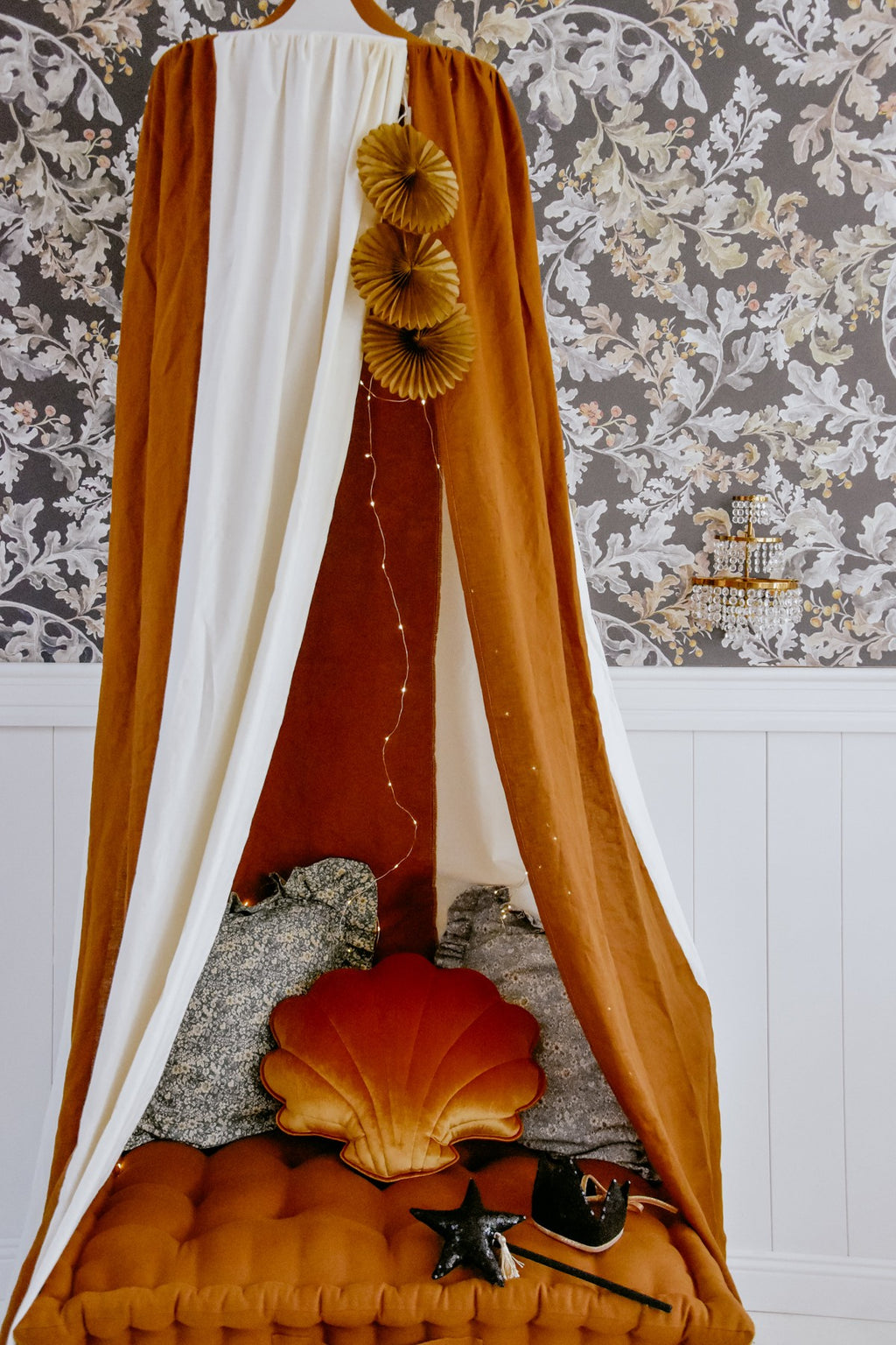 soft caramel and cream linen canopy draped gently over a cozy reading nook, with natural light filtering through