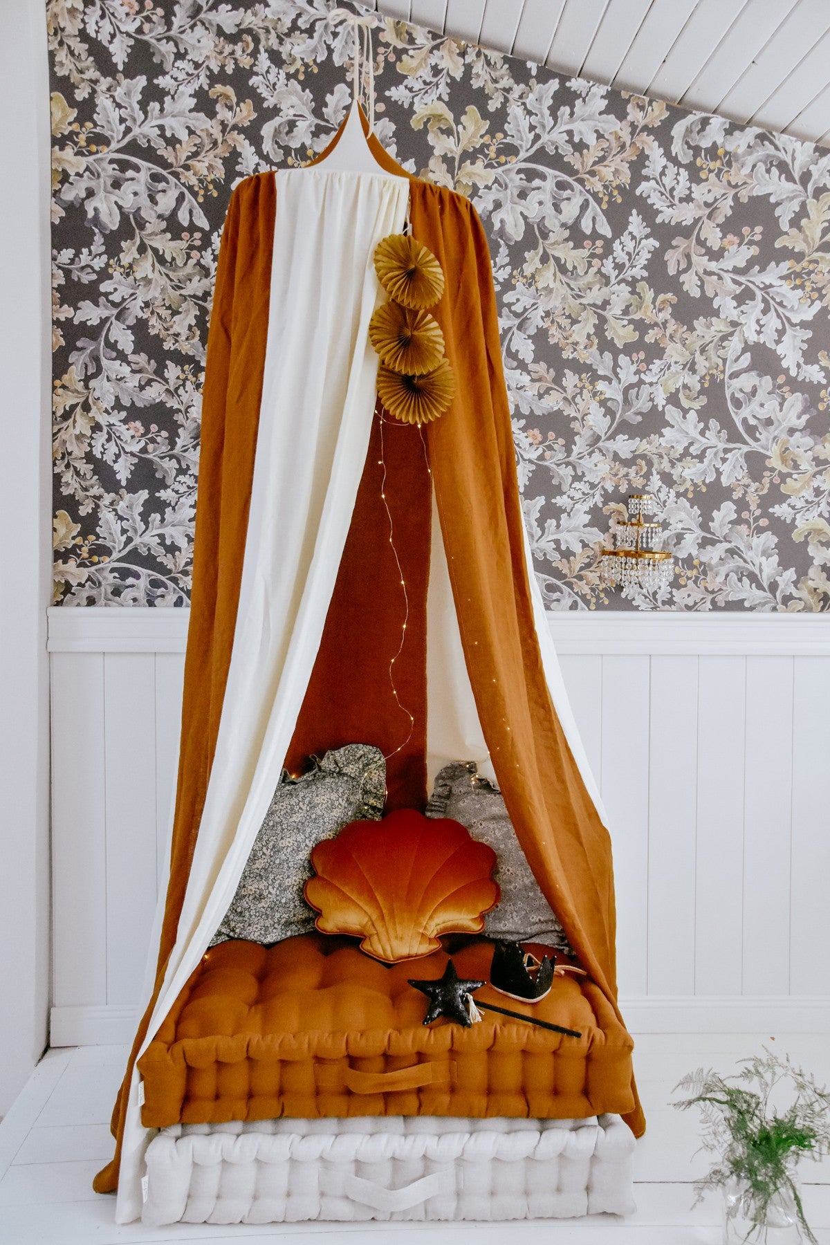 caramel circus organic cotton and linen canopy draped gracefully over a bed, soft light filtering through the fabric