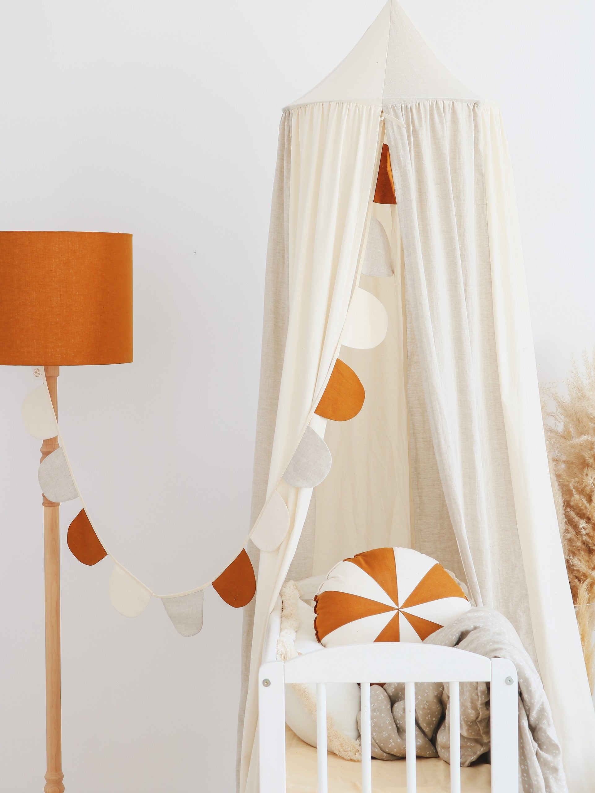 cream circus organic cotton and linen canopy draped elegantly over a bed, soft folds catching warm sunlight