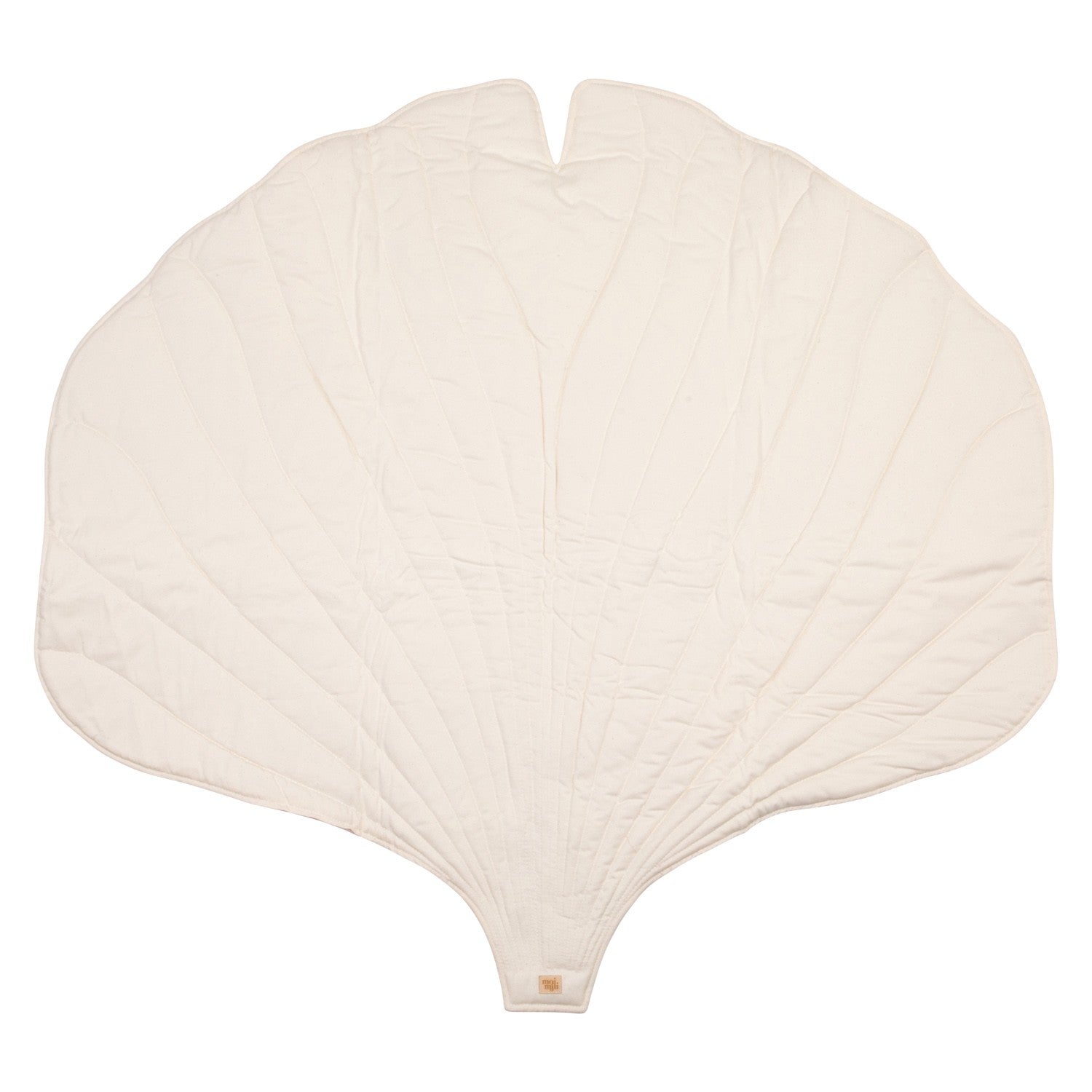 handmade ginkgo leaf playmat on a wooden floor, showcasing its soft cream texture and elegant double-sided design