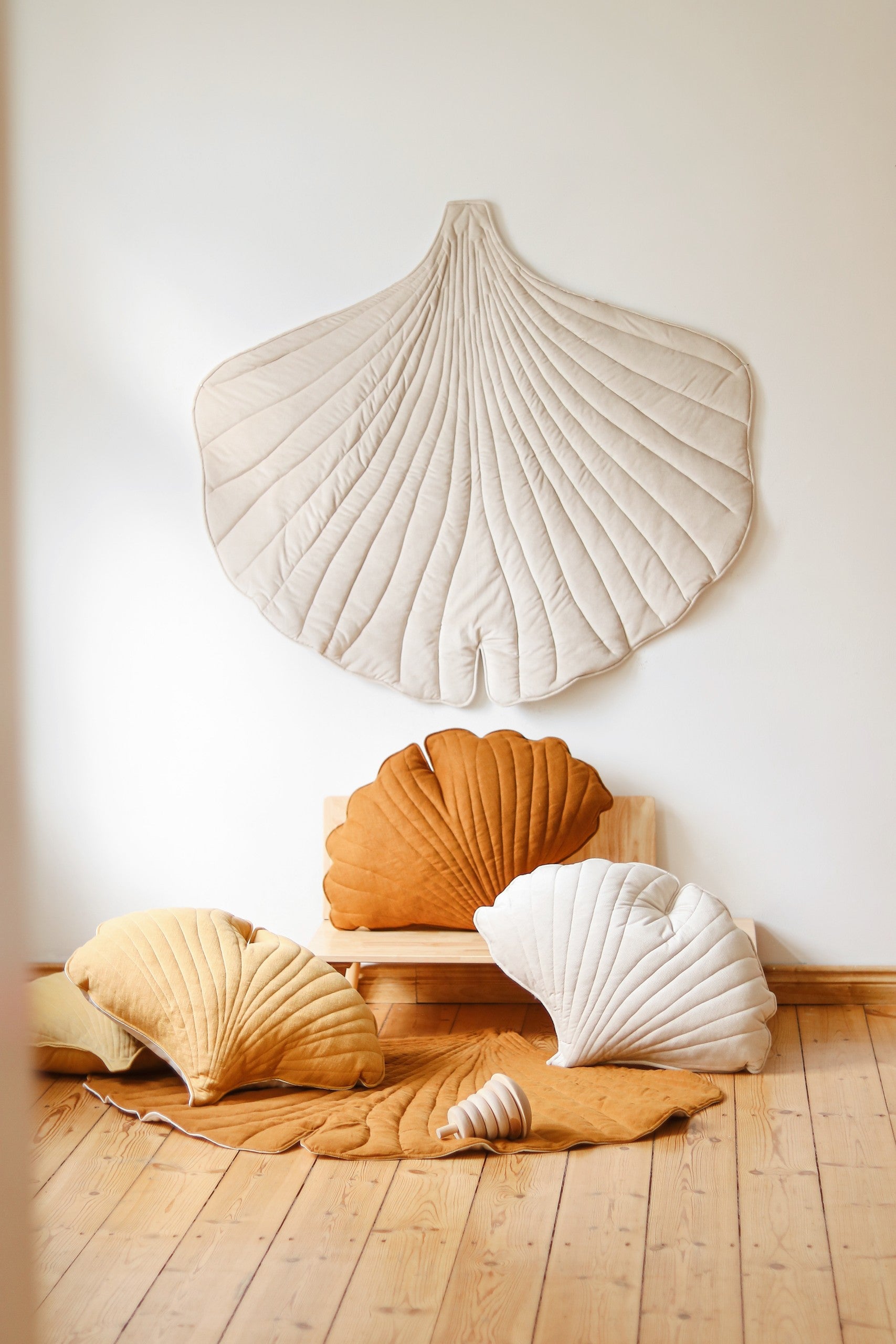 close-up of the ginkgo leaf playmat's 3cm thick edge and soft cream fabric
