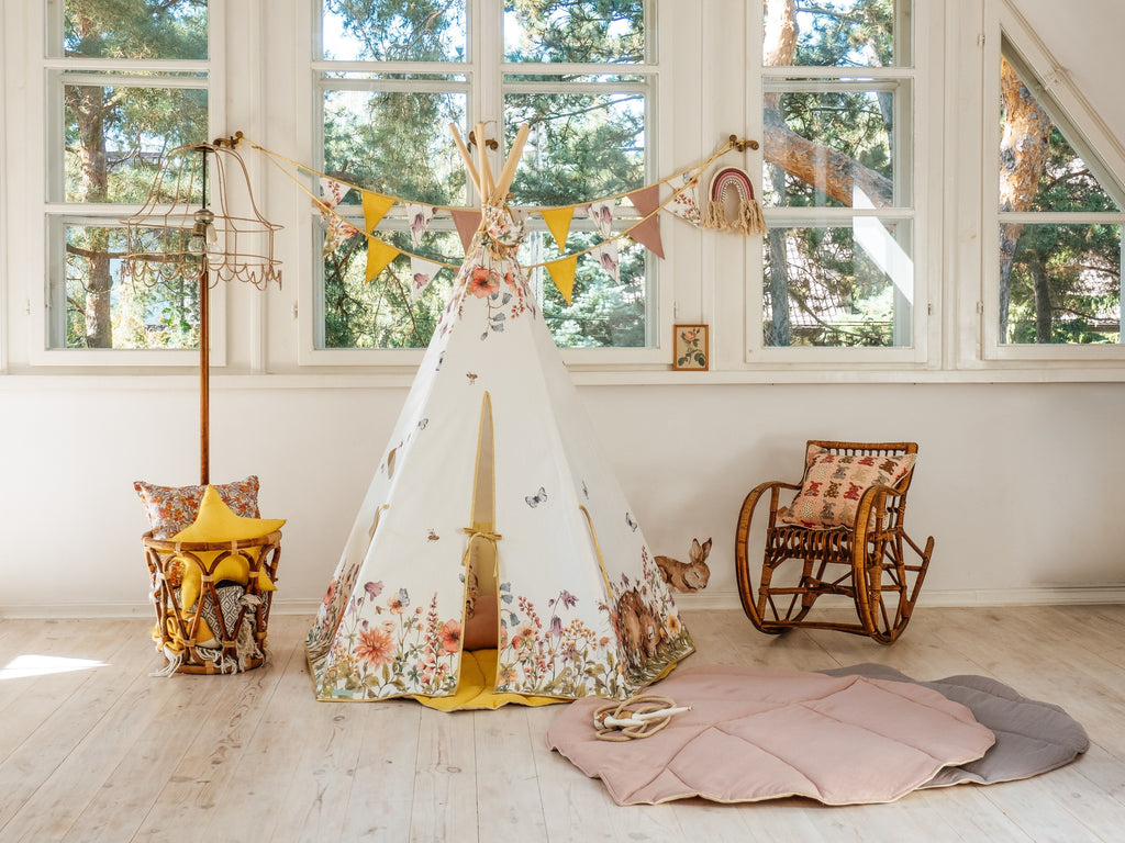 a soft pink organic leaf playmat on a cozy nursery floor, inviting gentle play and quiet moments