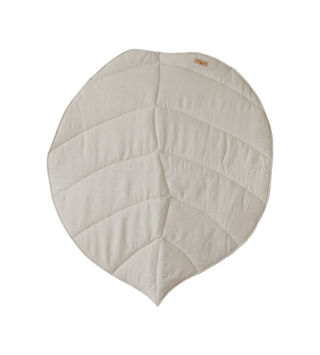 elegant sand-colored ginkgo leaf playmat displayed on a minimalist wooden floor