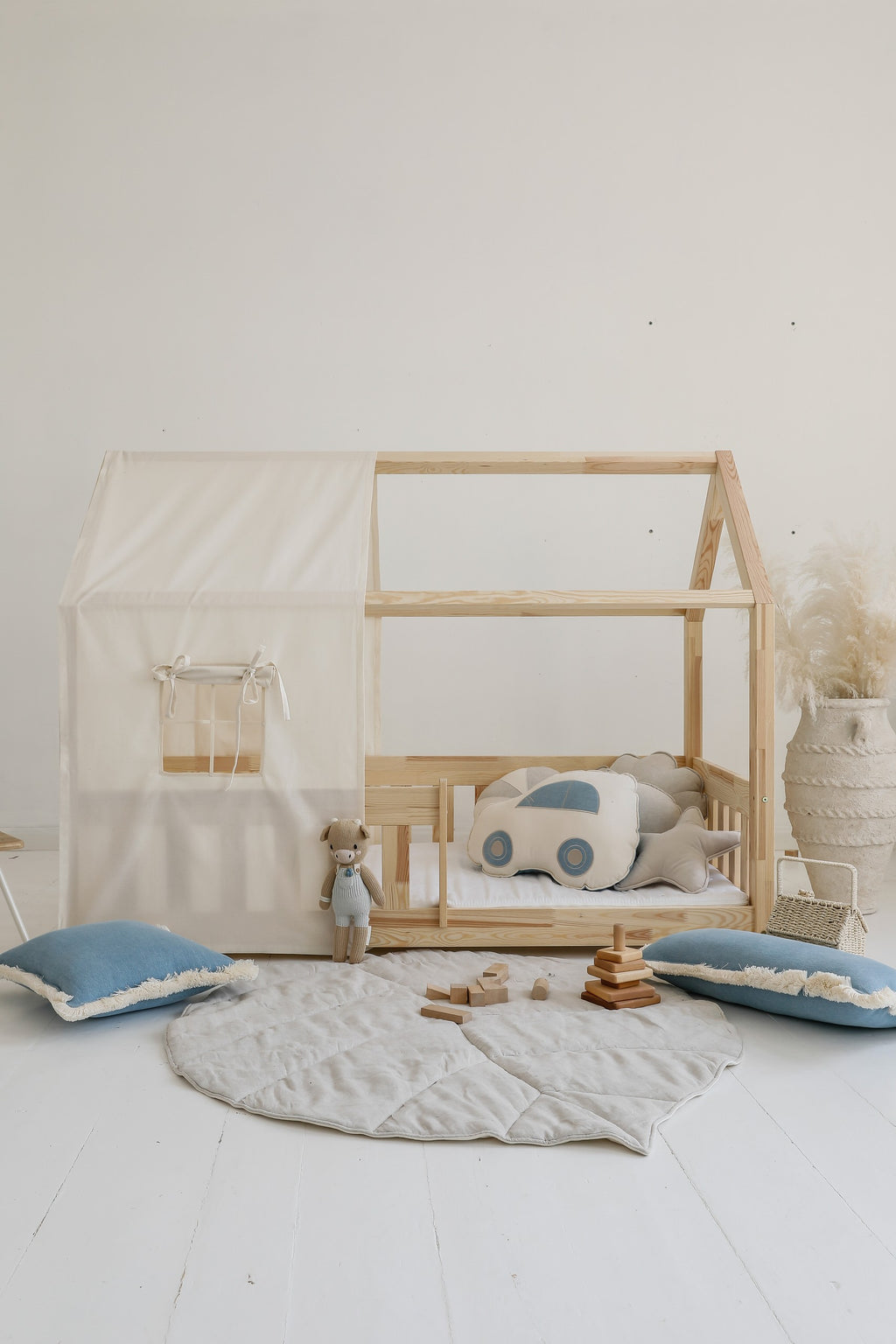 handmade ginkgo leaf playmat in sand displayed on a light wood floor, showcasing its elegant double-sided texture