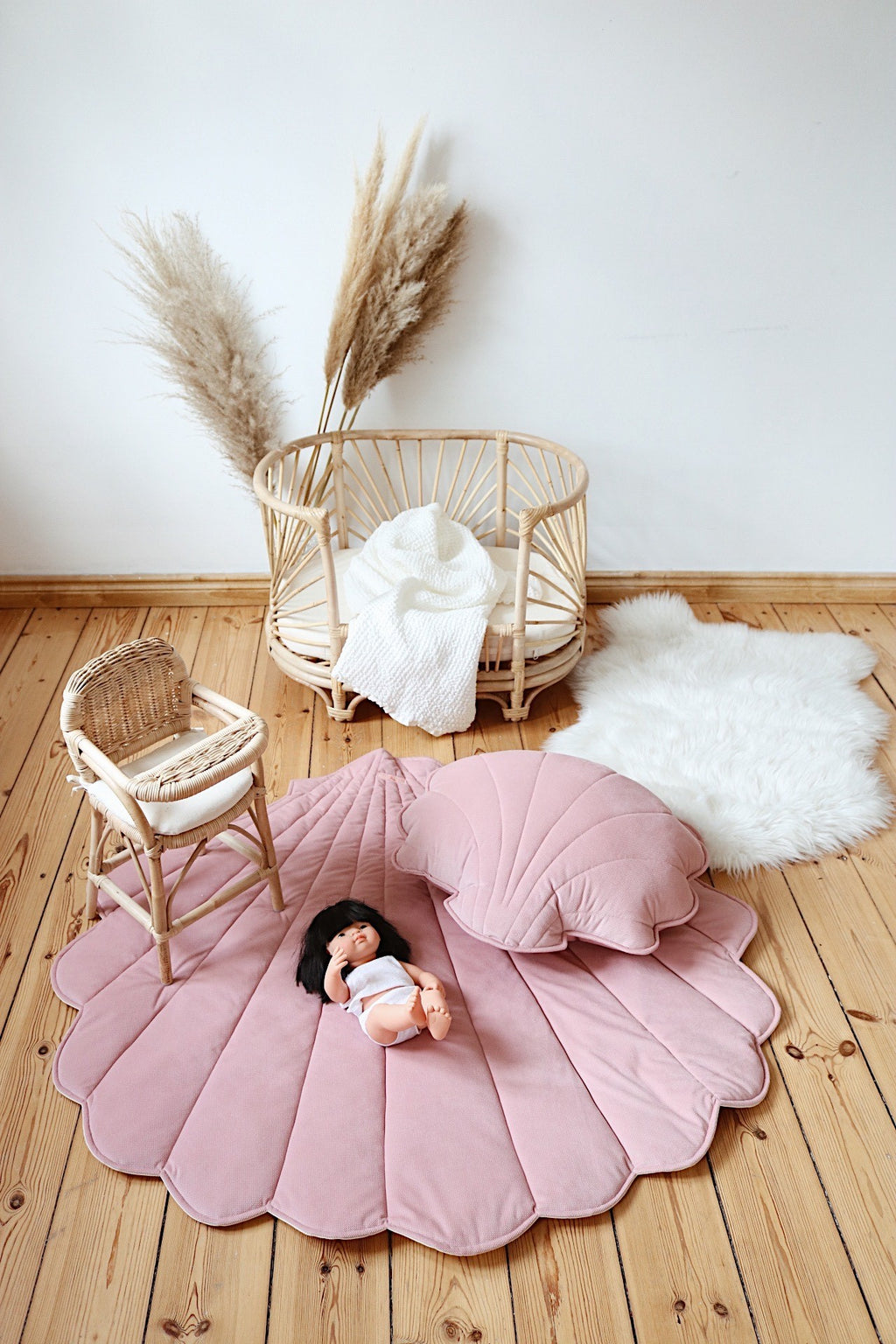 powder pink organic cotton and velvet ginkgo leaf playmat spread under a tree, soft and inviting