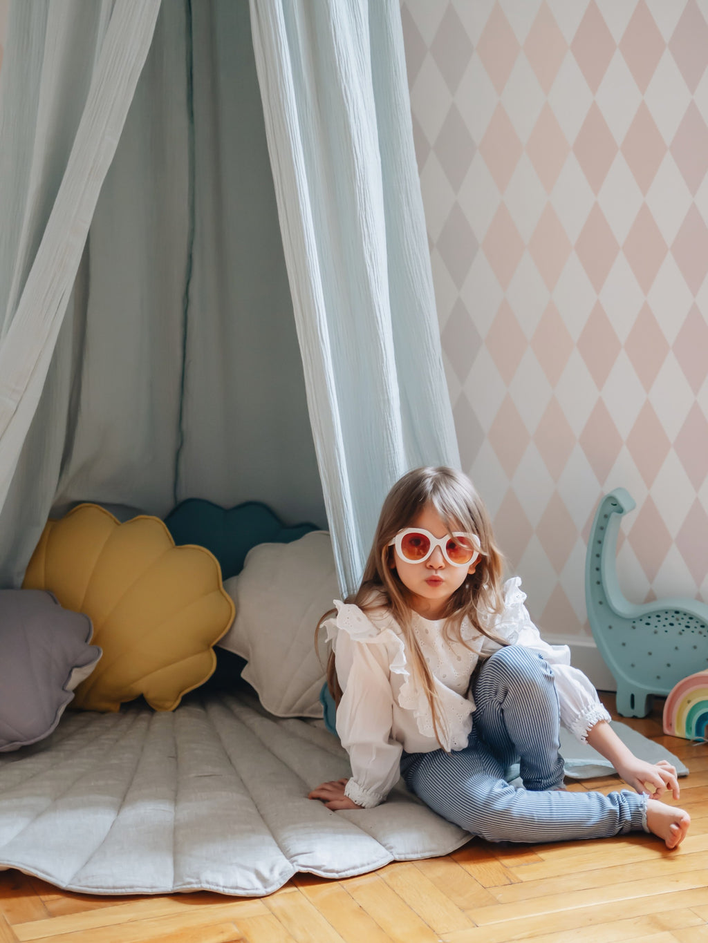 soft mint organic cotton canopy hanging over a childs bed in gentle morning light