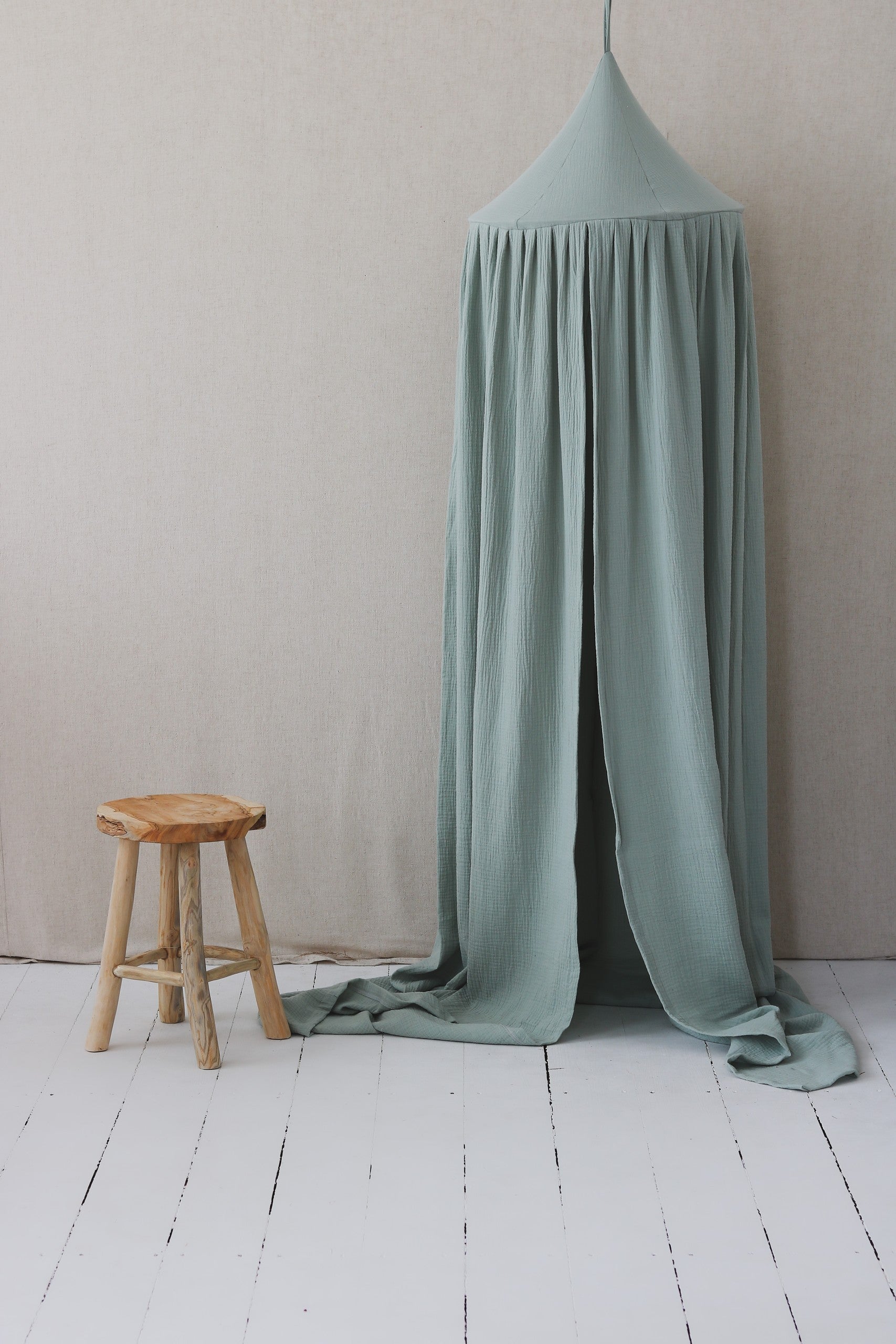 mint green organic cotton canopy with inside loop for hanging lights, shown in a bright room