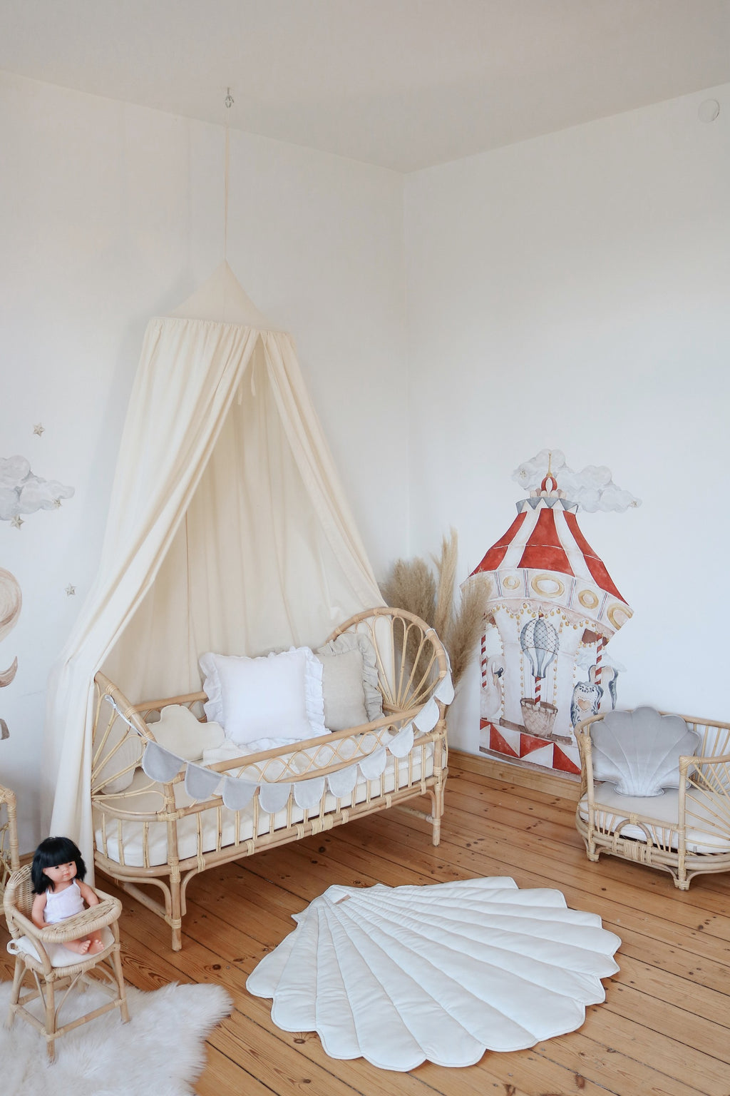 organic cotton canopy draped over a cozy reading nook with soft natural light filtering through
