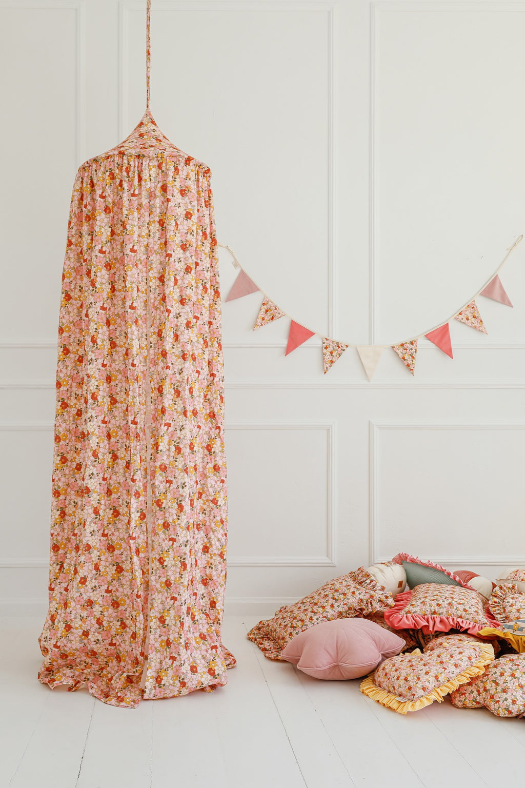 organic cotton canopy hung over a cozy reading nook with soft mint fabric draping naturally