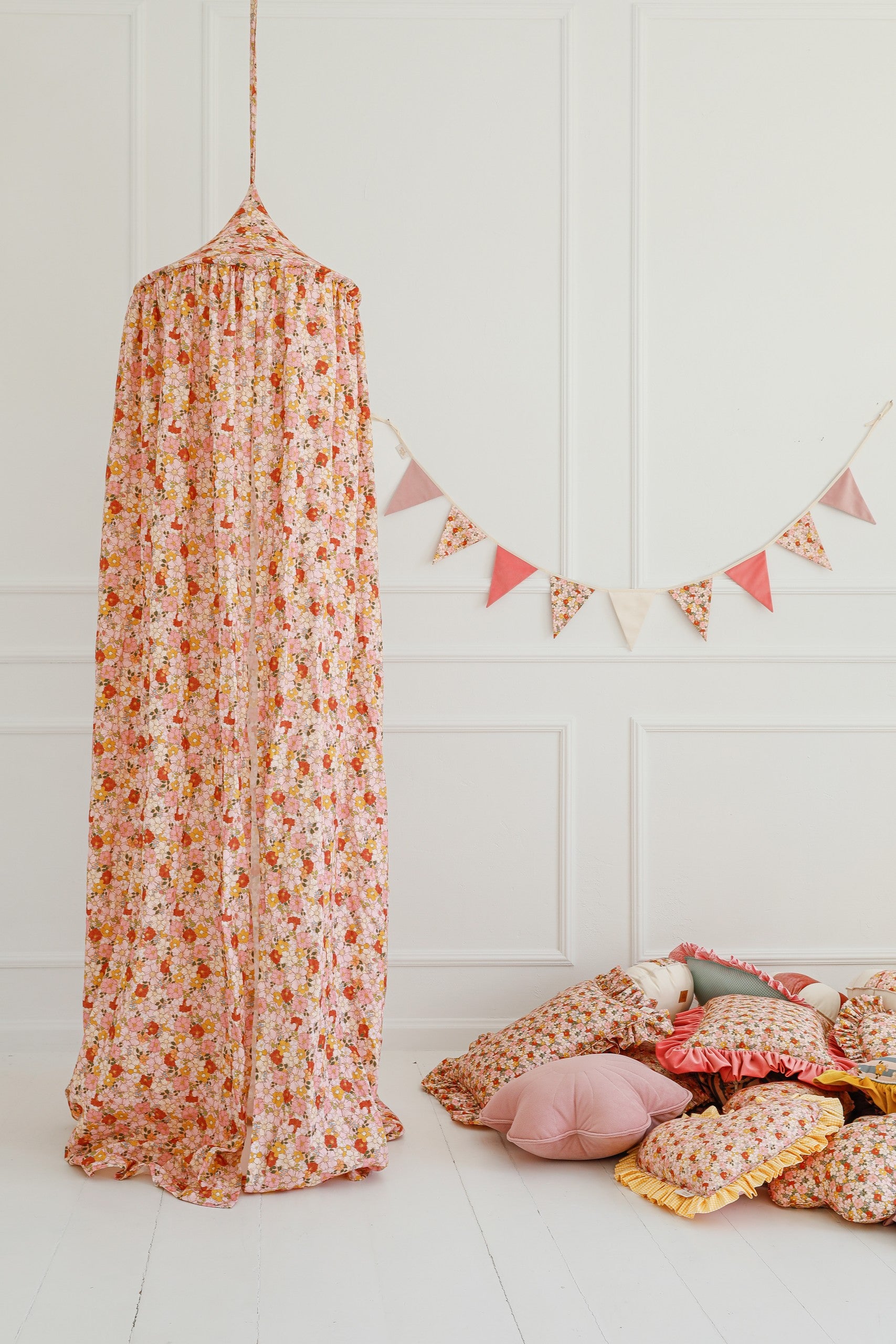 organic cotton canopy hung over a cozy reading nook with soft mint fabric draping naturally