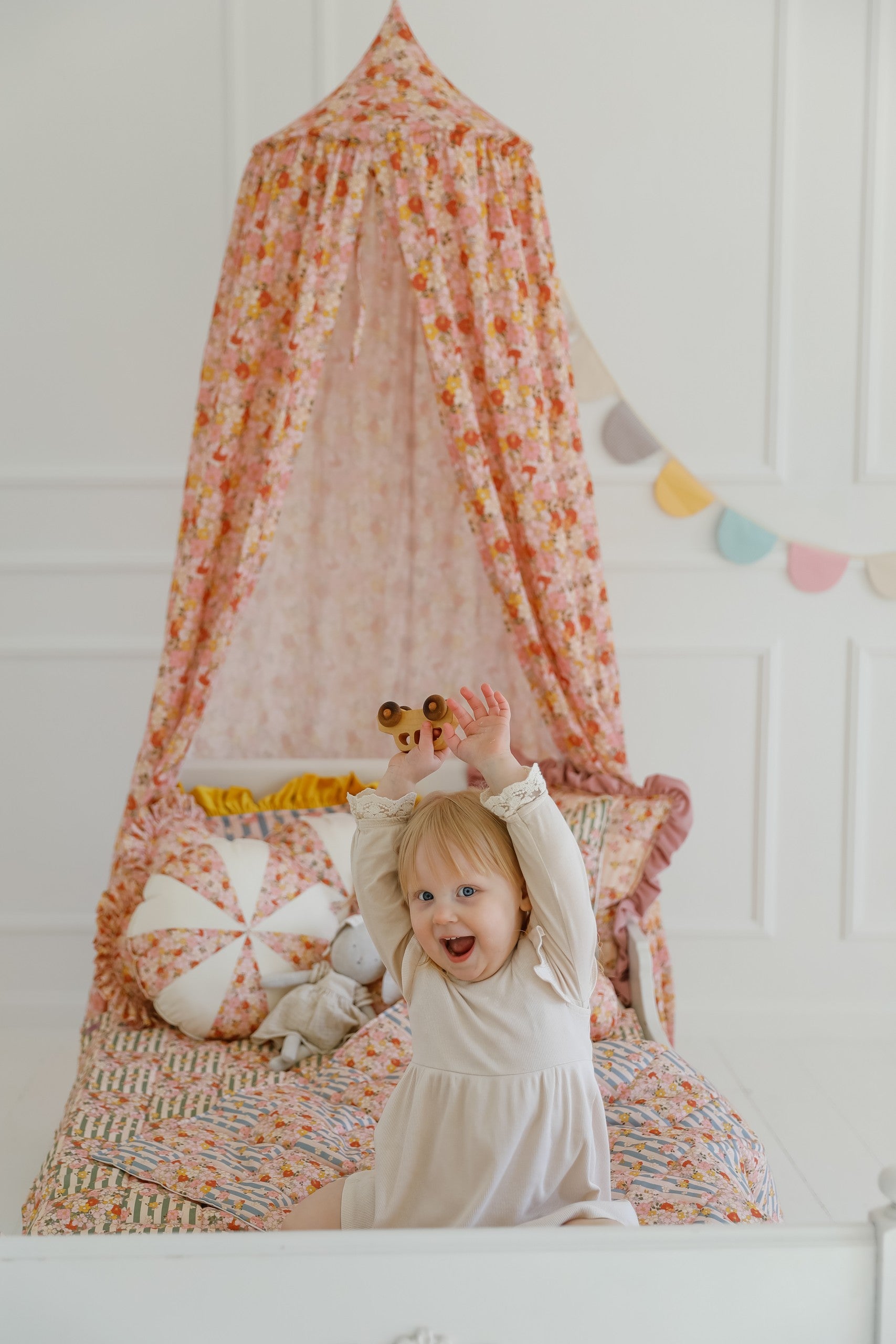 mint green organic cotton canopy draped over a bed with soft morning light filtering through
