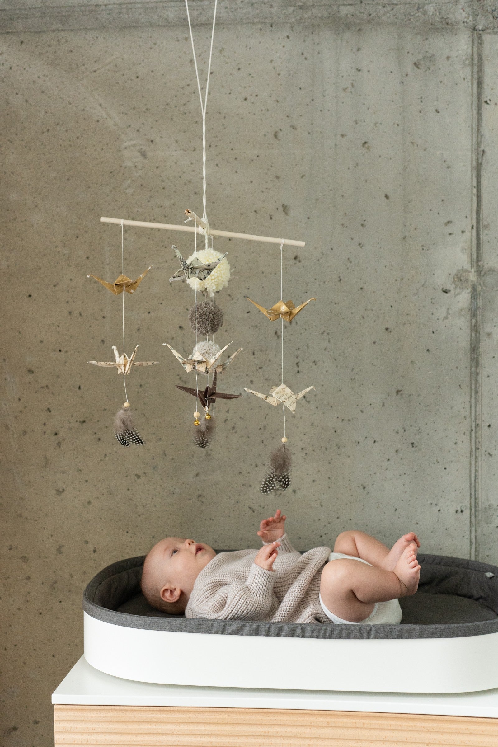 practical view of handmade origami mobile showing sturdy wooden stick and secure yarn attachment
